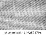Knitting pattern Knitted seamless background in gray. Knit textures for wallpapers and backgrounds.