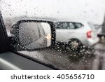 Raindrops on the car rearview mirror. Heavy rain outside