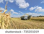 Small photo of Mikhailovka, Ukraine - August 25: Self-Propelled Forage Harvester John Deere 8300 and truck. Harvesting and processing in forage near the village Mikhailovka, Central Ukraine August 25, 2017