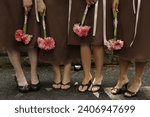 close up of bridesmaids holding flower bouquets at wedding 