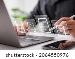 Paperless workplace idea, e-signing, electronic signature, document management. A businessman signs an electronic document on a digital document on a virtual notebook screen using a stylus pen. 
