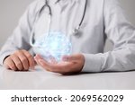 Small photo of Human brain in the hands of a general practitioner or neurologist. Brain disease and mental illness diagnosis concept photo in neurology, psychiatry, psychotherapy, psychology