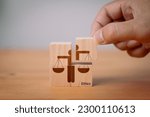 Small photo of Concept of business ethics and moral principles, as a hand holds wooden cubes with "ETHICS" symbols. This emphasizes the importance of business integrity, good governance policies and ethical
