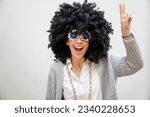 Small photo of A heartwarming scene of a woman striking a peace pose while laughing, expressing a genuine sense of happiness and positivity.