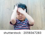 Small photo of Asian kid boy headache and Accident.Foster child with bad family.Sibling rivalry fighting.School Home harassment.Accident in toddler child kid.Insurance.epilepsy child.Brain injury.emergency.first aid