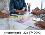 Small photo of Graphic designers, architects, and painters are in a meeting to discuss how to sketch a structure. Finding a home-style color scheme that fits and matches the purpose of the client in the office.