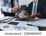Small photo of Asian male financial officer or accountant checking investment results Financial budget analysis Planning to summarize results and report to the meeting Audit concept and investment results.