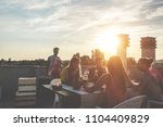 Small photo of Young friends having barbecue party at sunset on penthouse patio - Happy people doing bbq dinner outdoor cooking meat and drinking wine - Focus on left woman face - Food, fun and friendship concept