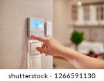 Woman hand adjusting temperature / thermostat