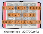 Small photo of Vancouver, BC, Canada - Circa April 2023: Scrabble letters spelling Bible Verse 1 Chronicles 22:12 Only the Lord give thee understanding