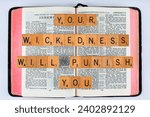 Small photo of Vancouver, BC, Canada - Circa Dec. 2023: Scrabble letters spelling Bible Verse Jeremiah 1:19 Your wickedness will punish you