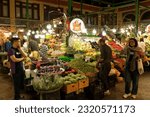 Small photo of Tehran, Iran - June 19, 2023: A farmer market in Tajrish Bazaar and Iranians buying fruit and vegetables. It's a part of Persian Culture to gather in public, fulfilling their needs, and eat afterward.