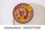 Small photo of Thai dessert and a beautiful placemat placed on a white background. This is Khao Mao Tod, a traditional Thai dessert menu. Top view dessert decorated with colorful flowers with simple style dish.