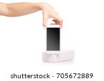 Female hand holding a mobile phone smartphone box on a white background isolation