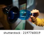 Small photo of Woman puts bottle in automatic bottle recycling machine. Reverse vending recycling machine.
