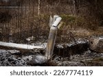 Small photo of A projectile from a rocket stuck into the ground, light snow