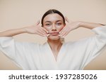 Small photo of Young woman doing face building facial gymnastics self massage and rejuvenating exercises touching lips