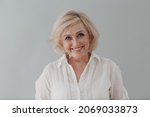 Small photo of Elderly caucasian old aged woman portrait gray haired smiling portrait. Concept of affordable dentures and implants