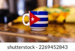 Small photo of Cuban cofee cup with cuban flack and blurred background