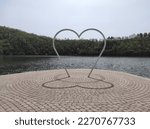 Heart shaped statue by the lake. Brick patio. 