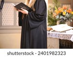 Small photo of Female Vicar holds service in a Protestant church
