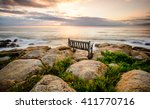 Bench Overlooking A Sea Sunset