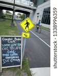 Small photo of MINNEAPOLIS, MINNESOTA / USA - AUGUST 16, 2016: Sandwich board sign for Coaster Break Cafe in Freewheel Bike Shop by Midtown Greenway bike trail.