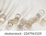 Small photo of Top view white sparkling wine in different glasses of wine, stemmed glass with sun shadow palm leaf on light beige background. White wine tasting concept flat lay, copy space. Summer alcoholic drinks