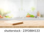 Small photo of Selective focus.End grain wood counter top with cutting board on blur kitchen in morning window background.For montage product display or design key visual