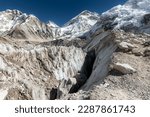 Small photo of Detail of Khumbu glacier crevasse in the Everest Base Camp. Edge of Nuptse west face and summit of Mount Everest in the background