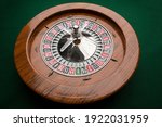 Wooden roulette isolated on green background