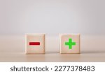 Small photo of Wooden blocks showing plus and minus signs. The concept of antithesis. Decision making. Positive or negative business choice. Analysis of advantages and disadvantages Comparison