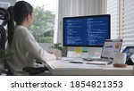 Small photo of Back rear view of young asian woman, freelance data scientist work remotely at home coding programing on Big data mining, AI data engineering, IT Technician Works on Artificial Intelligence Project.