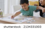 Small photo of Little cute boy son enjoy fun learn offline class computer language game Unplugged Coding computing STEM STEAM with mom. Asia pupil kindergarten gen Z smart small kids smile play at table home sofa.