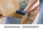 Small photo of Eco vendor go green packaging parcel carton box in net zero waste store asian seller retail shop. Earth care day small SME owner asia people wrap reuse brown paper pack gift reduce plastic free order.
