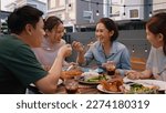 Small photo of Mom enjoy thai meal cooking for family day meet talk home dining at dine table cozy patio. Group asia people young adult man woman friend fun joy relax warm night time picnic eat yummy food with mum.