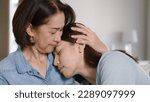 Small photo of Middle aged asia people old mom love care trust comfort help young teen talk crying stress relief at home. Mum as friend listen adult child woman feel pain sad worry of broken heart life crisis issues