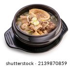 Small photo of Beef bone marrow soup in hot iron pot isolated on white background, Beef Stock Bone soup or Seolleongtang in iron pot on white With clipping path.