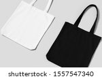 Small photo of White and black tote bags mockup on a grey background.