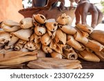 Small photo of hands making mexican tamales kneaded in a clay pot, piloncillo tamales made with black corn, homemade traditional mexican dish.
