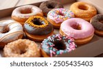 Glazed and decorated donuts in a box, showcasing a variety of flavors and toppings, with vibrant icing colors, set on a wooden table, perfect for a sweet treat or dessert