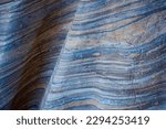 Closeup on a undulating abstract geologic pattern in a rock wall smoothed by eons of erosion, Death Valley National Park, California