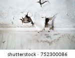 Ceiling and wall with rain damage due to violent weather and roof damage                               