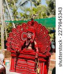 Small photo of Theyyam is a popular ritualistic art form that originated in the northern part of Kerala state in India. It is a form of worship that combines dance, music