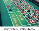 Small photo of Thrilling casino moment: the classic roulette wheel spins on an elegant table, capturing the excitement of high-stakes gaming in sophisticated surroun
