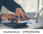 Small photo of Close up Man hands calculating number, data, graph, chart audit planning accountancy on business report. Business man hands using calculator counting tax financial bill. Tax audit Finacial concept.