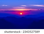 Scenic view dramatic beautiful sunset sky. Natural Sunset Sunrise on meadow silhouette shadow dark land. Vibrant dramatic sky on sunset, dawn, sunrise in Countryside. Landscape Colorful Sky At Sunset