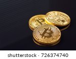 Gold bitcoin coin stacked against a dark background close-up. Bitcoin cryptocurrency                               