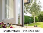 Small photo of Cambridgeshire, UK - Circa July 2019: Brand new isntalled double glazing windows seen in a house annex. Detail of the multiple window locks can rubber window sealing is visible, adjacent to a garden.