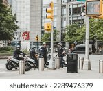 Small photo of New York City, USA - Circa October 2016: Group of NYPD officers seen having a group discussion with some of them dismounted from there NYPD scooters. Seen near Central Park.